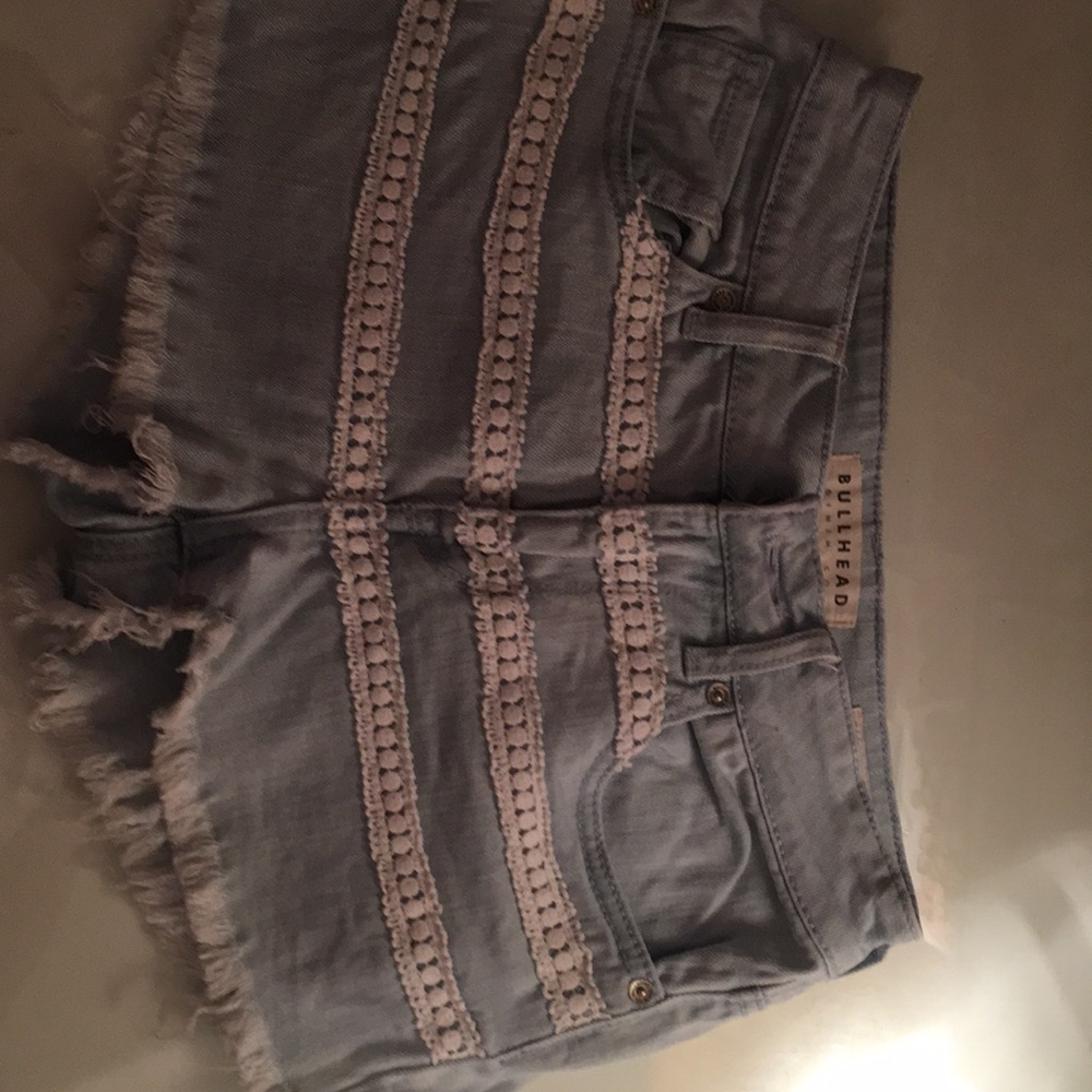 Light wash denim cutoff shorts with lace